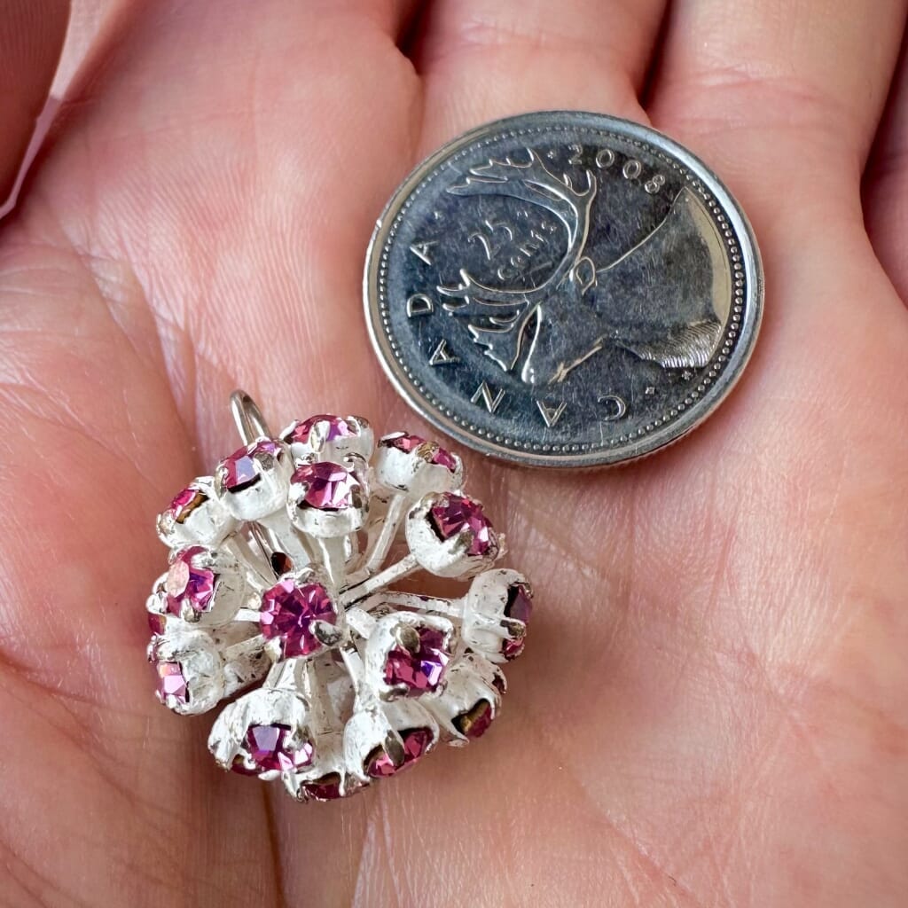 Vintage, Swarovski rhinestone bead ball, rose-coloured stones and white metal, on a pink background.