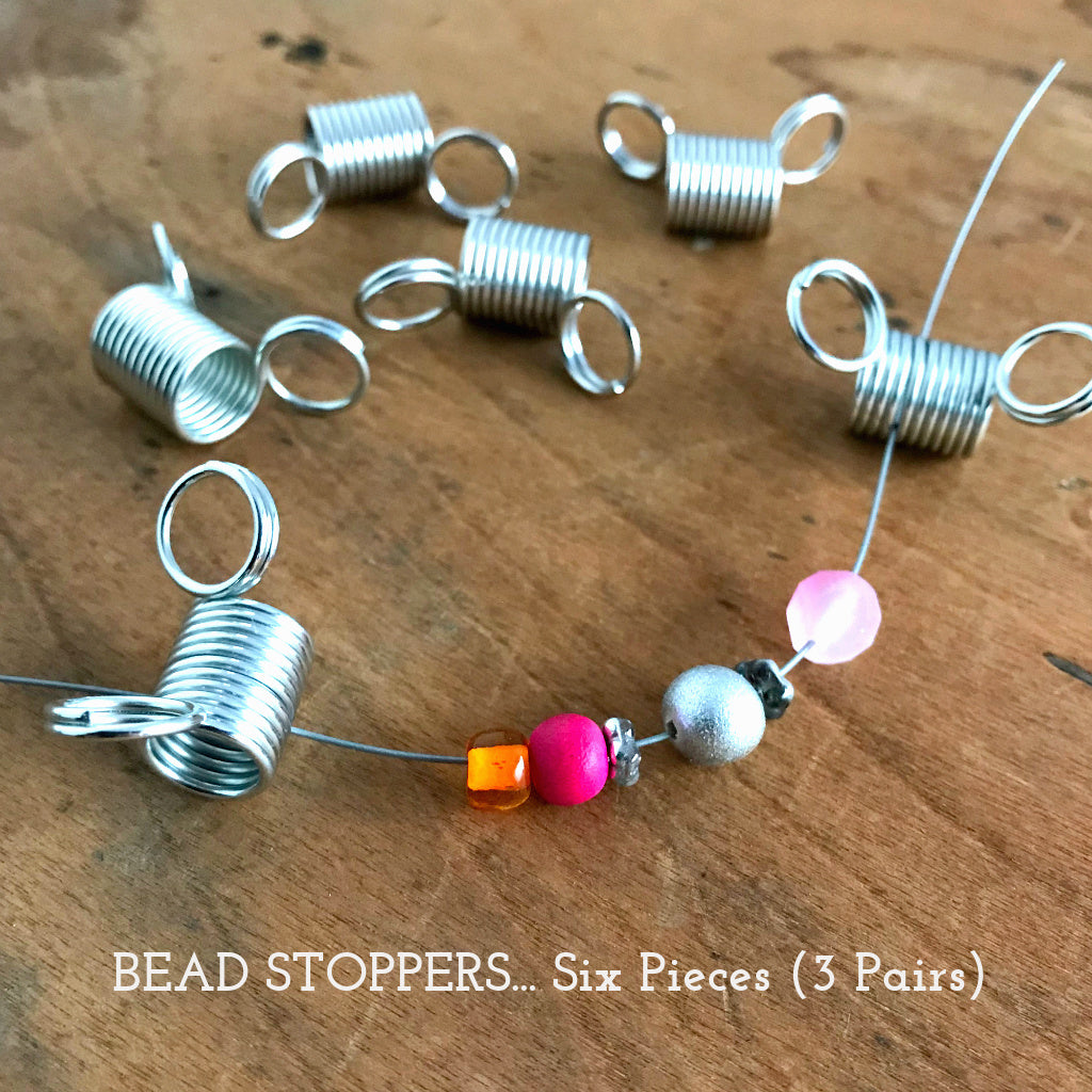 Suzie Q Studio's “must have” bead stringing invention, the Bead Stopper, prevents the beads on your bead stringing wire from slipping off the end while you create your design. They’re super-easy to use… Simply squeeze the rings to open the coils, slide in your bead stringing wire, release the rings and you’re ready.
