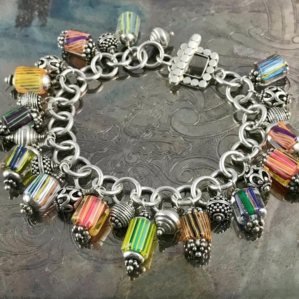 Amazingly, every single component used to create this fun Suzie Q Studio charm bracelet was handcrafted: sterling silver jump rings, handblown art glass beads, intricate sterling silver beads -- all were made by silver artisans in Bali… A truly, one-of-a-kind, happy bracelet!