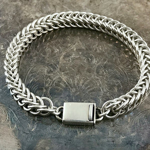 This Suzie Q Studio handmade sterling silver chain bracelet is perfect for both guys and gals, with its sleek look and secure box-style clasp. Substantial, 16 gauge sterling silver jump rings were woven together to create this Half Persian chain that’ll wrap lusciously around your wrist.
