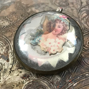 One-of-a-kind MY MOTHERS BUTTONS jewelry is handcrafted using the finest antique treasures. Glass-domed Horse Bridle Rosettes were a decoration for horse bridles. Suspended under the glass dome of this pendant is an angelic-looking flower girl image.  