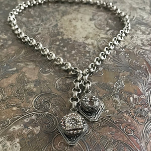 One-of-a-kind MY MOTHERS BUTTONS jewelry is handcrafted using thefinest antique buttons. The detailing of the buttons in this necklace isexceptional, especially the cornucopia motif!