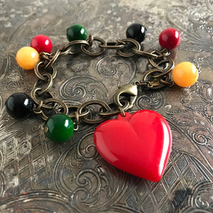 Suzie Q Studio carries HOTCAKES DESIGN retro-style, handmade jewelry taking its inspiration from classic Bakelite jewelry, vintage images and bold color.  This fun and festive charm bracelet will jazz up any outfit and make your heart sing with its luscious heart and colorful charms.