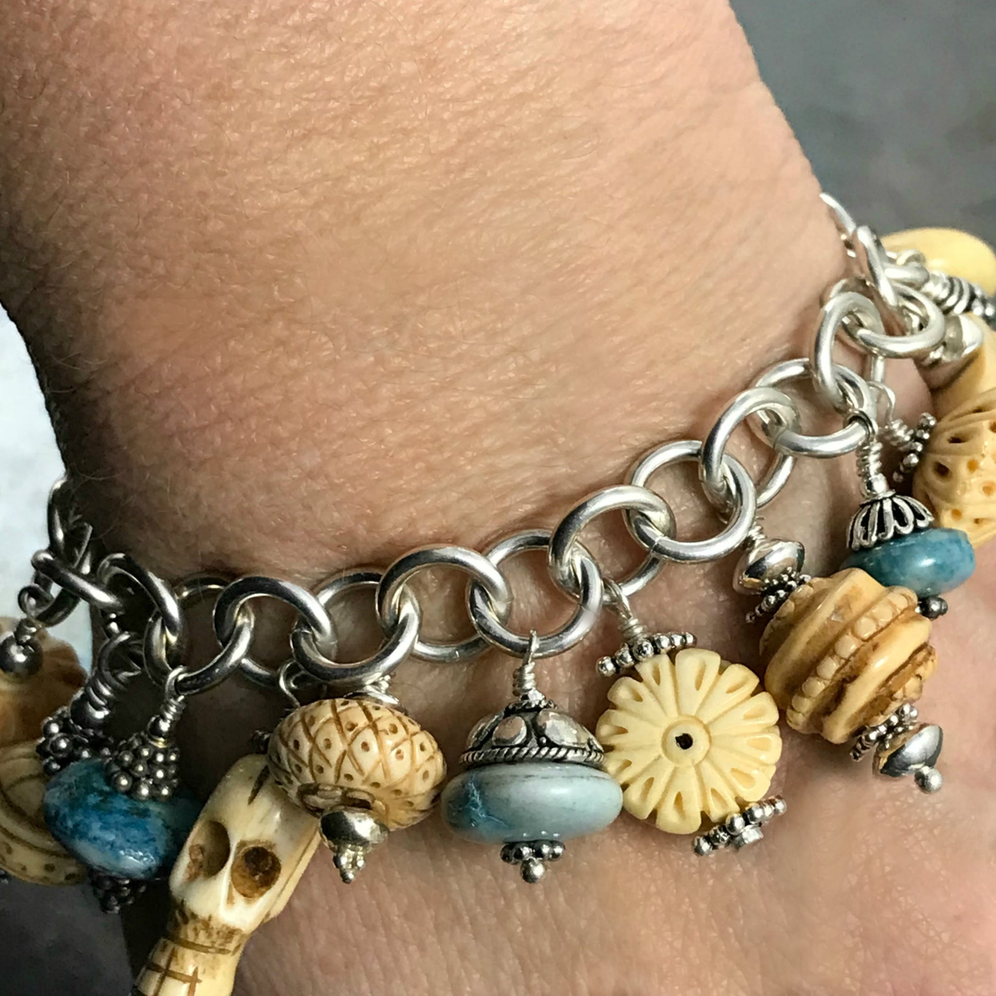 TURQUOISE AND CARVED BONE CHARM BRACELET