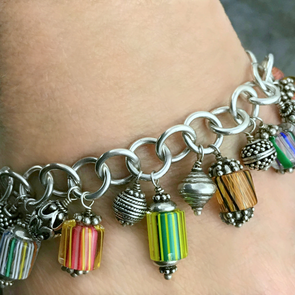 Amazingly, every single component used to create this fun Suzie Q Studio charm bracelet was handcrafted: sterling silver jump rings, handblown art glass beads, intricate sterling silver beads -- all were made by silver artisans in Bali… A truly, one-of-a-kind, happy bracelet!