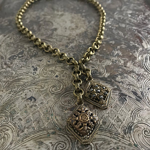 One-of-a-kind MY MOTHERS BUTTONS jewelry is handcrafted using the finest antique buttons. The intricate filigree work in the two vintage buttons featured in this necklace are super-pretty!