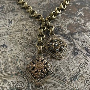 One-of-a-kind MY MOTHERS BUTTONS jewelry is handcrafted using the finest antique buttons. The intricate filigree work in the two vintage buttons featured in this necklace are super-pretty!