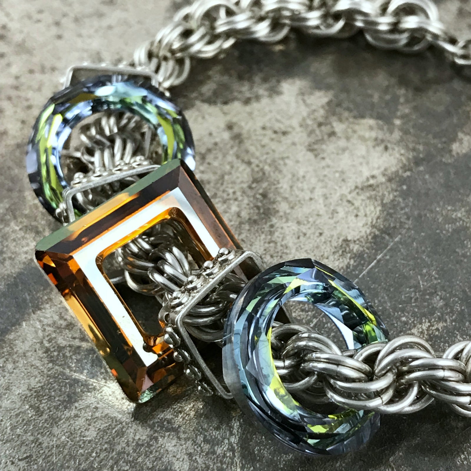 Available at Suzie Q Studio - Sterling silver chain bracelet with Swarovski crystal. Sterling silver rings are intricately woven together to create this fabulous double spiral chain bracelet. 