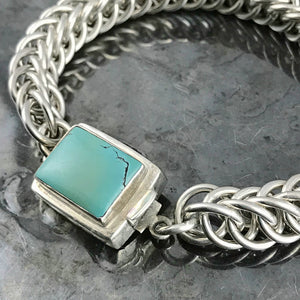 ​This striking Suzie Q Studio bracelet was created by hand-weaving 14 gauge, hand-cut, sterling silver jump rings into a pattern called “Half-Persian Weave”. Topped off with a sterling silver box-style clasp, which features a beautiful turquoise stone. Definitely a classic!