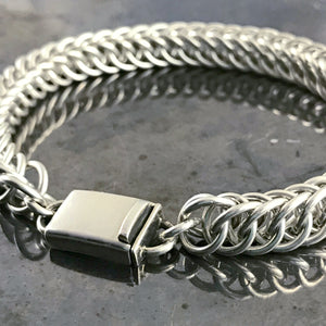 This Suzie Q Studio handmade sterling silver chain bracelet is perfect for both guys and gals, with its sleek look and secure box-style clasp. Substantial, 16 gauge sterling silver jump rings were woven together to create this Half Persian chain that’ll wrap lusciously around your wrist.