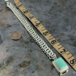 ​This striking Suzie Q Studio bracelet was created by hand-weaving 14 gauge, hand-cut, sterling silver jump rings into a pattern called “Half-Persian Weave”. Topped off with a sterling silver box-style clasp, which features a beautiful turquoise stone. Definitely a classic!