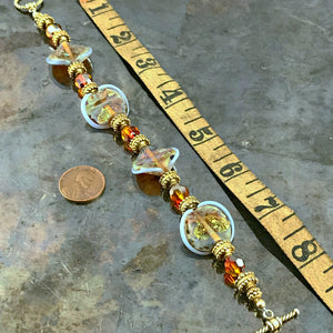 The individually made, handblown glass beads on this Suzie Q Studio bracelet are exquisite! Combined with Swarovski crystals, “vermeil gold” beads and toggle closure, makes this eye-catching bracelet perfect for almost any occasion.