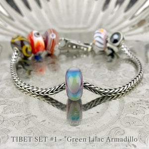Now available at Suzie Q Studio, the ultra-rare Trollbeads Tibet Beads. This shows the Green Lilac Armadillo bead in Tibet Bead set 1.