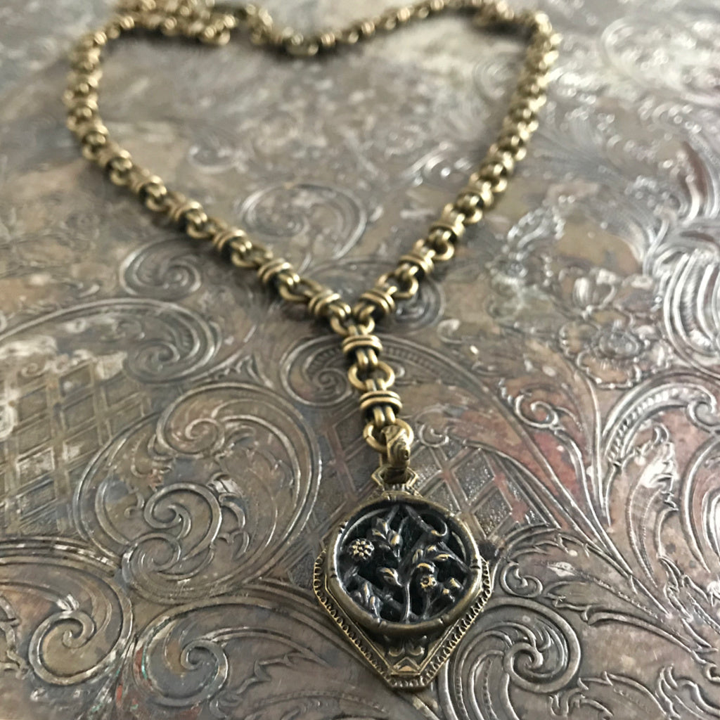 One-of-a-kind MY MOTHERS BUTTONS jewelry is handcrafted using the finest antique buttons. With beautiful flowers in an English country garden, this “Y”-style necklace is perfect for someone who's passionate about gardening.