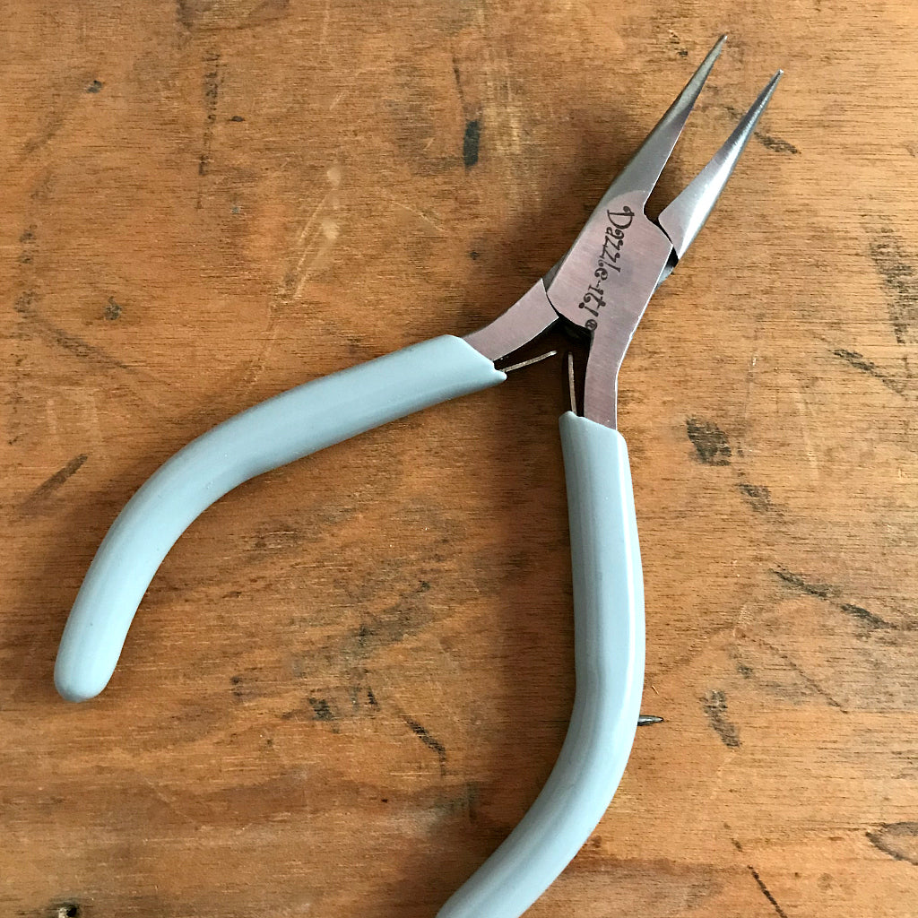 When it comes to making jewelry, if you want professional looking results, using Suzie Q Studio's jewelry-making tools is the way to go! The “Bent Chain Nose Plier” is ideal for griping and bending. As well, because of their extra-pointy nose and curved jaws, they're able to get into even tighter spots than the regular Chain Nose Plier!