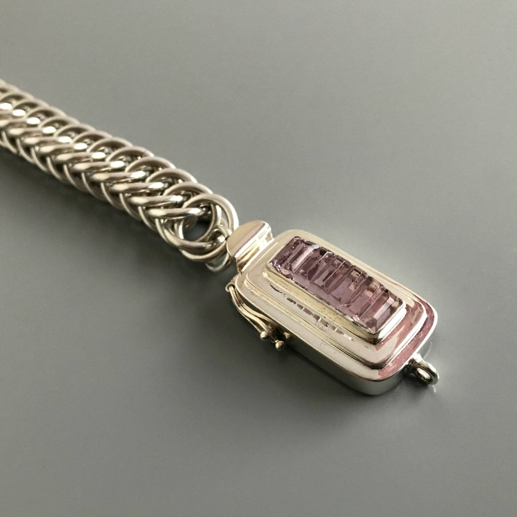 This Suzie Q Studio sterling silver custom box clasp was handcrafted with a skinny rectangle-shaped, vintage glass cabochon, with wonderful geometric ridges along the surface of it. The delicate, lilac-colored glass, juxtaposed with the strong carved lines, gives this box clasp a soft, yet dynamic look. 