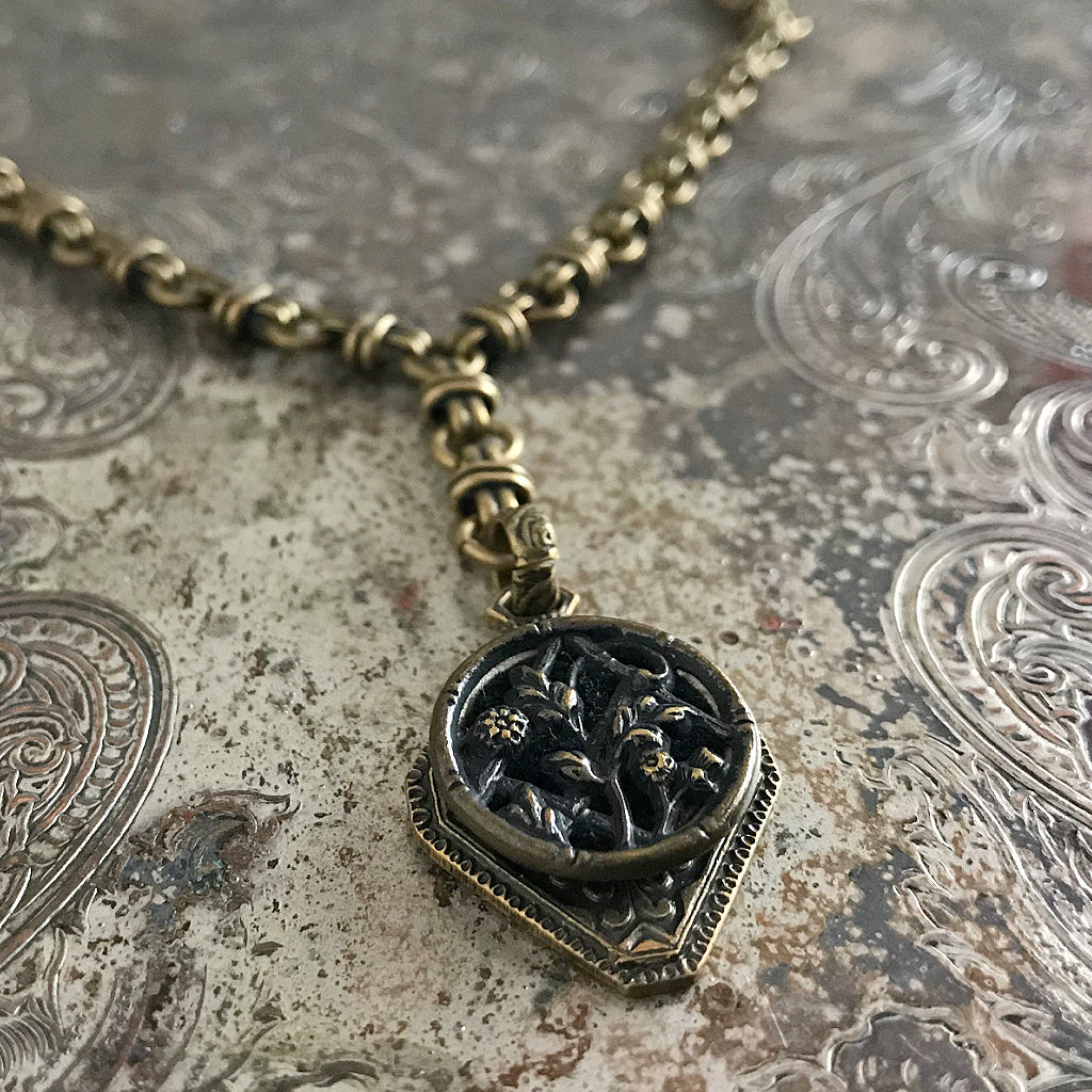 One-of-a-kind MY MOTHERS BUTTONS jewelry is handcrafted using the finest antique buttons. With beautiful flowers in an English country garden, this “Y”-style necklace is perfect for someone who's passionate about gardening.