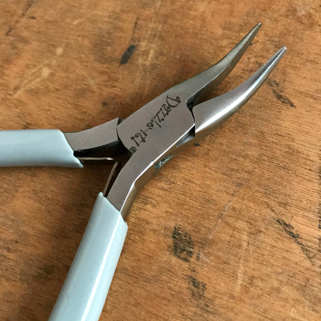 When it comes to making jewelry, if you want professional looking results, using Suzie Q Studio's jewelry-making tools is the way to go! The “Bent Chain Nose Plier” is ideal for griping and bending. As well, because of their extra-pointy nose and curved jaws, they're able to get into even tighter spots than the regular Chain Nose Plier!