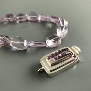 This Suzie Q Studio sterling silver custom box clasp was handcrafted with a skinny rectangle-shaped, vintage glass cabochon, with wonderful geometric ridges along the surface of it. The delicate, lilac-colored glass, juxtaposed with the strong carved lines, gives this box clasp a soft, yet dynamic look. 