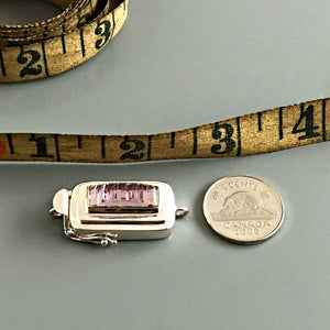 This Suzie Q Studio sterling silver custom box clasp was handcrafted with a skinny rectangle-shaped, vintage glass cabochon, with wonderful geometric ridges along the surface of it. The delicate, lilac-colored glass, juxtaposed with the strong carved lines, gives this box clasp a soft, yet dynamic look. 