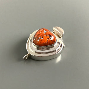 This Suzie Q Studio sterling silver custom box clasp is a very unusual and distinctive closure. The triangle shape of this vintage glass cabochon coupled with the mottled, burnt orange color on a base of silver “leaf”, showcases a retro-1950’s feel as well!