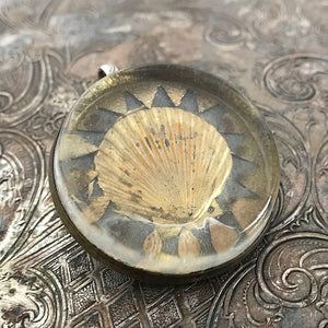 One-of-a-kind MY MOTHERS BUTTONS jewelry is handcrafted using the finest antique treasures. Glass-domed, bridle rosettes were a decoration for horse bridles. This pendant features a golden seashell design.