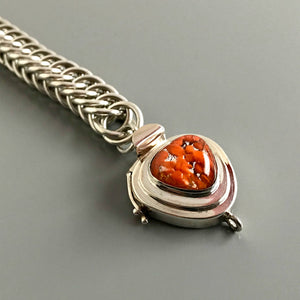 This Suzie Q Studio sterling silver custom box clasp is a very unusual and distinctive closure. The triangle shape of this vintage glass cabochon coupled with the mottled, burnt orange color on a base of silver “leaf”, showcases a retro-1950’s feel as well!