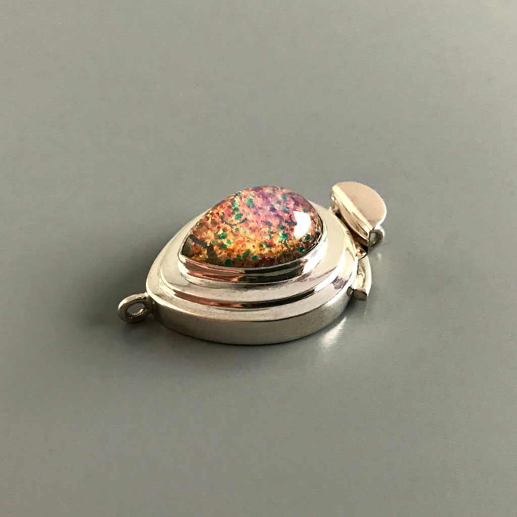 With the look of fire trapped under glass, this teardrop-shaped “Harlequin” vintage glass cabochon is simply stunning and will turn your jewelry design into a “showstopper”! This Suzie Q Studio custom box clasp was handcrafted with a substantial amount of sterling silver.