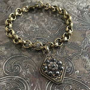 One-of-a-kind MY MOTHERS BUTTONS jewelry is handcrafted using the finest antique buttons. This flower-shaped design on this simple, but elegant bracelet has amazing detailing! 
