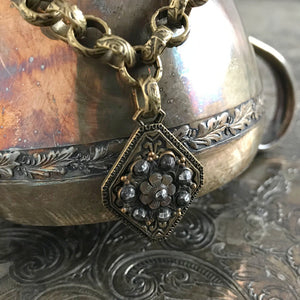 One-of-a-kind MY MOTHERS BUTTONS jewelry is handcrafted using the finest antique buttons. This flower-shaped design on this simple, but elegant bracelet has amazing detailing! 