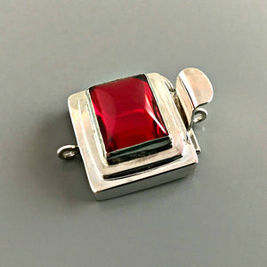 If you love red, this Suzie Q Studio box clasp is for you The color is absolutely scrumptious - not too orangey or too bluish! This custom box clasp was handcrafted with a vintage glass cabochon and set in a substantial amount of sterling silver to create a statement-making piece of jewelry.
