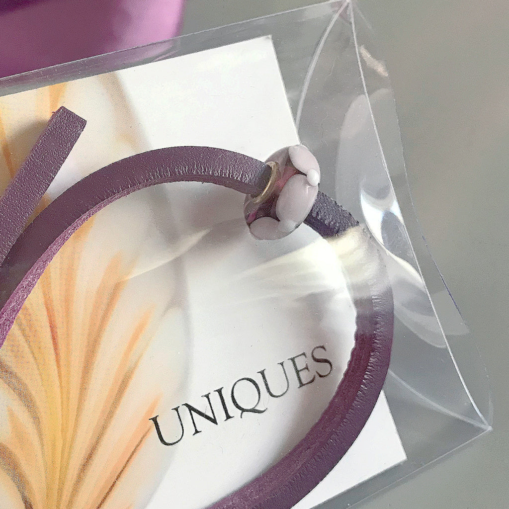 Trollbeads UNIQUES are one-of-a-kind glass beads handmade individually by 100% artisan-owned workshops. This Suzie Q Studio UNIQUES glass bead is perfect for the person who loves all things purple.
