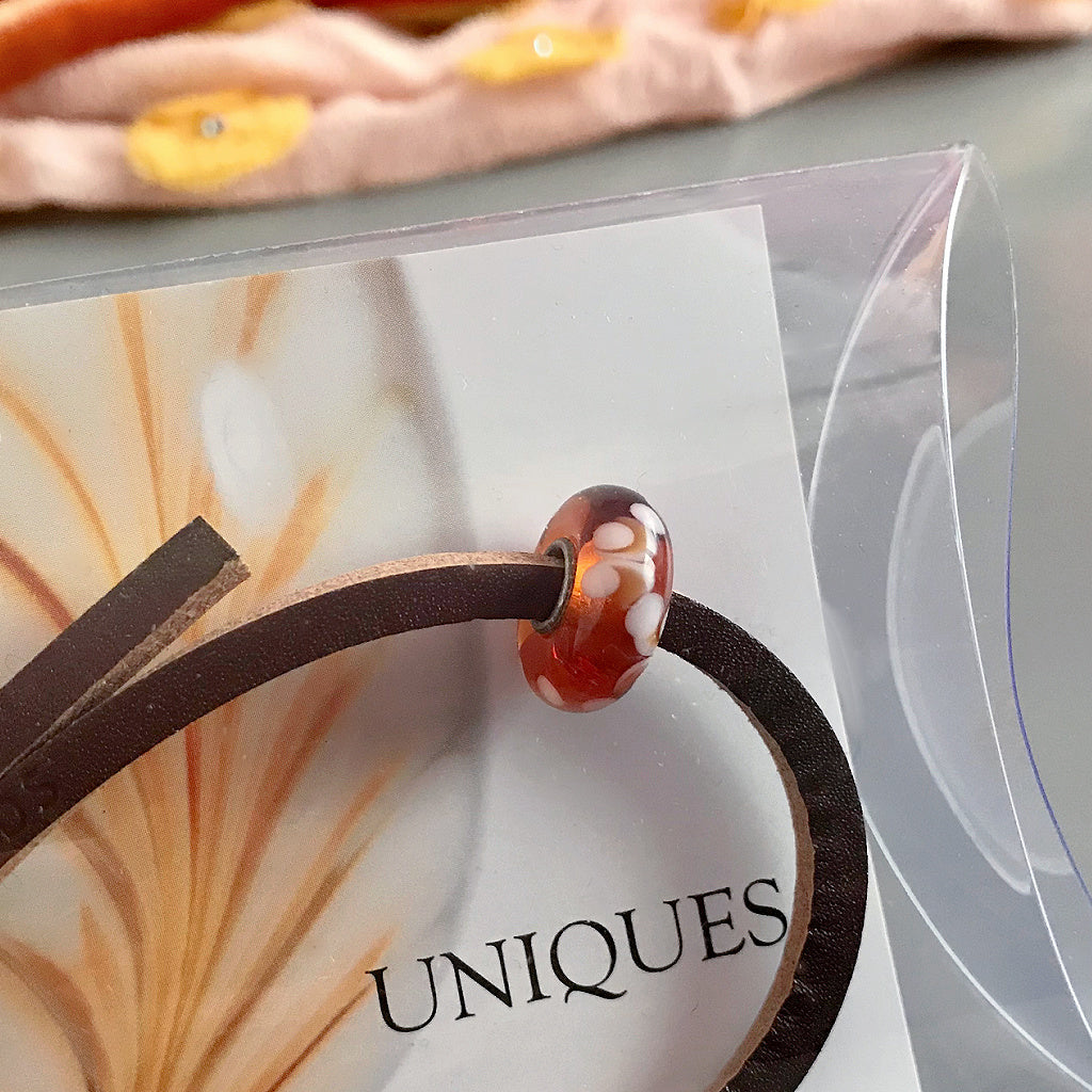 This super-sweet Suzie Q Studio Trollbeads UNIQUES glass bead bracelet looks like scrumptious maple syrup candy that you make on snow and has a leather bracelet.