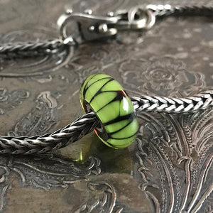 Suzie Q Studio has stashed away special glass, sterling silver and limited edition Trollbeads pieces in the Suzie Q Studio “Troll Treasures Vault”. This Trollbeads Glass Bead Collection features some rare beauties, including this luscious Green Shade bead. We’re adding lots more to our Trollbeads Rare and Retired Collection so check back often!