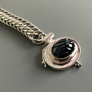 This Suzie Q Studio single-strand, custom box clasp was handcrafted with an exquisite, oval-shaped “carved” vintage glass cabochon in a hematite stone-style finish and set in a substantial amount of sterling silver, which gives this fab closure a look that can be casual, classic or totally upscale.
