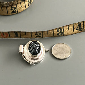 This Suzie Q Studio single-strand, custom box clasp was handcrafted with an exquisite, oval-shaped “carved” vintage glass cabochon in a hematite stone-style finish and set in a substantial amount of sterling silver, which gives this fab closure a look that can be casual, classic or totally upscale.