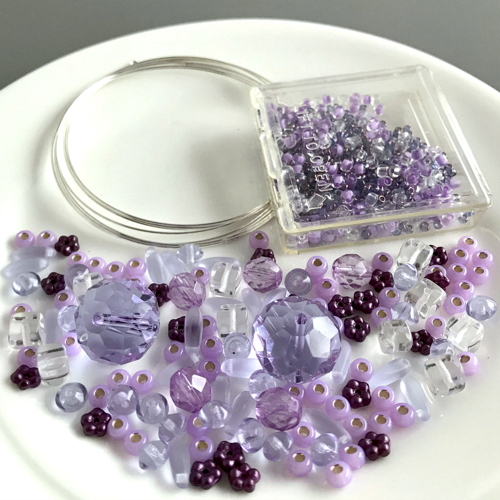 Suzie Q Studio's Serendipity BEAD STEW DIY EASY BRACELET MAKING KITS are limited edition collections of artfully curated premium quality beads and components for you to make a one-of-a-kind bracelet(s). No experience needed!  "Lavender Sweets" Kit contains various shades and tones of lavender and violet.