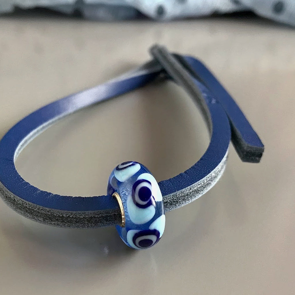 Trollbeads UNIQUES are individually handmade, one-of-a-kind glass beads. This fab Suzie Q Studio UNIQUES glass bead showcases a variety of blue tones - perfect to wear with denim.