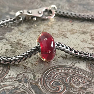 Suzie Q Studio has stashed away special glass, sterling silver and limited edition Trollbeads pieces in the Suzie Q Studio “Troll Treasures Vault”. This Trollbeads Glass Bead Collection features some rare beauties, such as this luscious Red Bubbles bead.