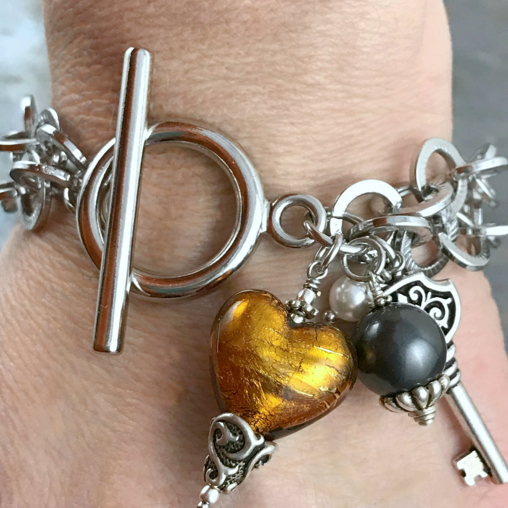 This Suzie Q Studio one-of-a-kind bracelet features a gorgeous, amber-coloured, handblown Italian Murano glass heart, a key charm, as well as Swarovski glass pearl accents and the neutral colours will coordinate with just about any outfit in your closet. 