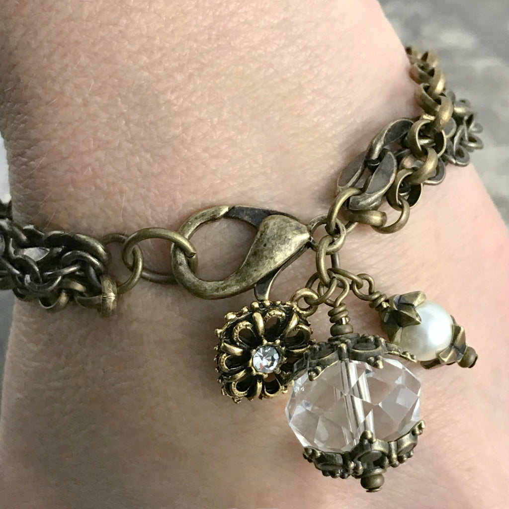 The crystal and pearl charms suspended from multiple strands of antique bronze-coloured chain, give this gorgeous, one-of-a-kind Suzie Q Studio bracelet a romantic feel from days gone by.