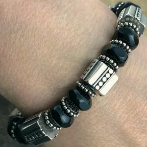 The exquisite sterling beads in this Suzie Q Studio bracelet are combined with a secure, vintage glass, sterling silver box-style clasp and black Czech pressed-glass beads to give this bracelet a timeless, classic look.