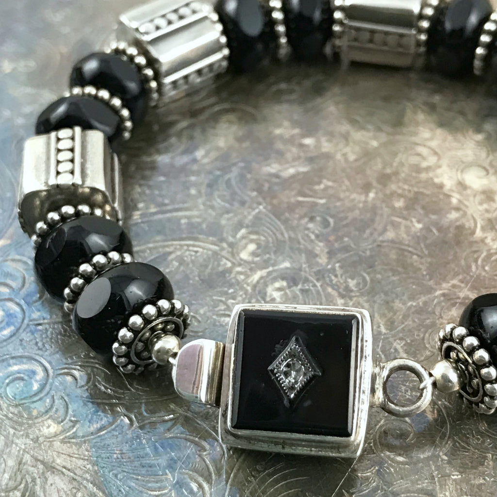 The exquisite sterling beads in this Suzie Q Studio bracelet are combined with a secure, vintage glass, sterling silver box-style clasp and black Czech pressed-glass beads to give this bracelet a timeless, classic look.