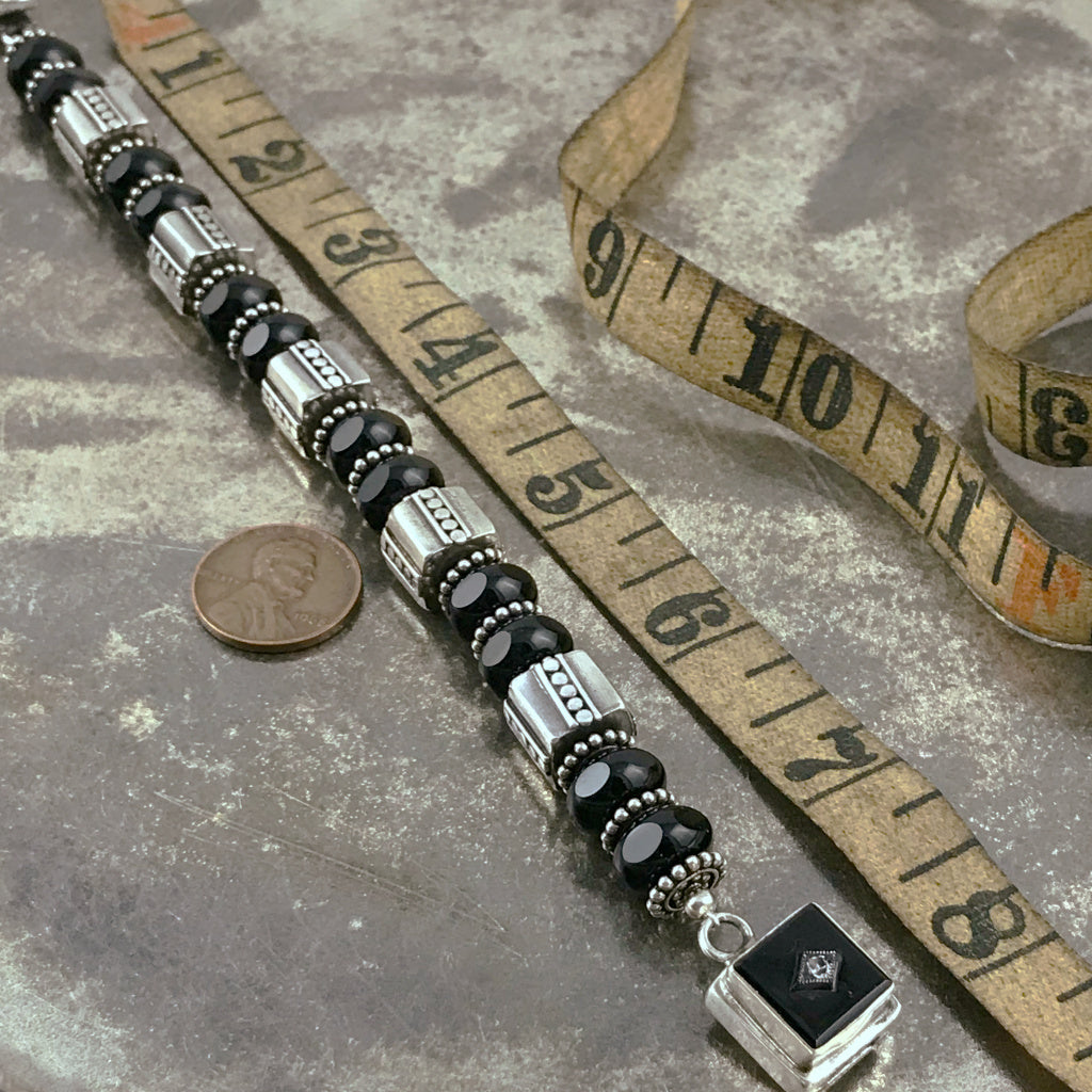 The exquisite sterling beads in this Suzie Q Studio bracelet are combined with a secure, vintage glass, sterling silver box-style clasp and black Czech pressed-glass beads to give this bracelet a timeless, classic look.