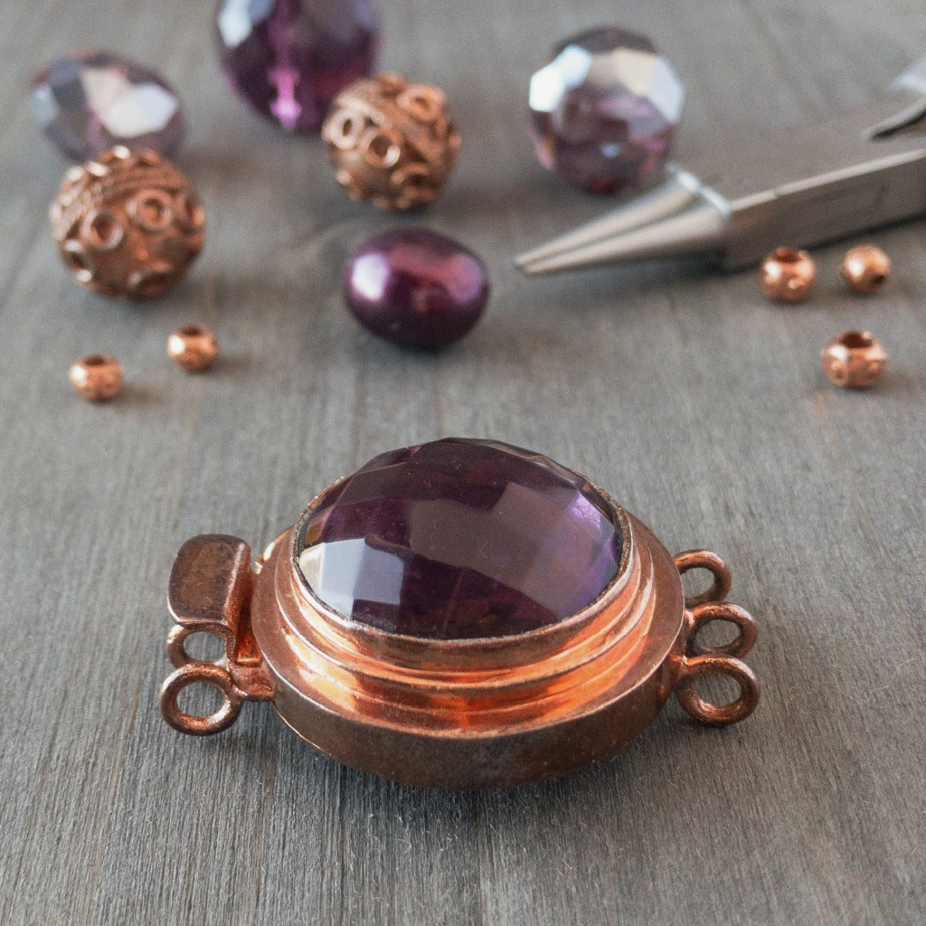 This unique box clasp showcases a warm, amethyst-coloured, vintage, faceted glass cabochon, and is surrounded by copper that has a beautiful natural, antique patina finish. It was individually handcrafted in 100% pure copper, exclusively for Suzie Q Studio.