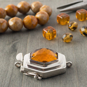 In addition to the uncommon diamond shape of the vintage glass cabochon in this sterling silver box clasp, the rich amber colour gives this piece an ultra-luscious look that would totally lend itself to mixing gold metal with the silver, if you so desired.