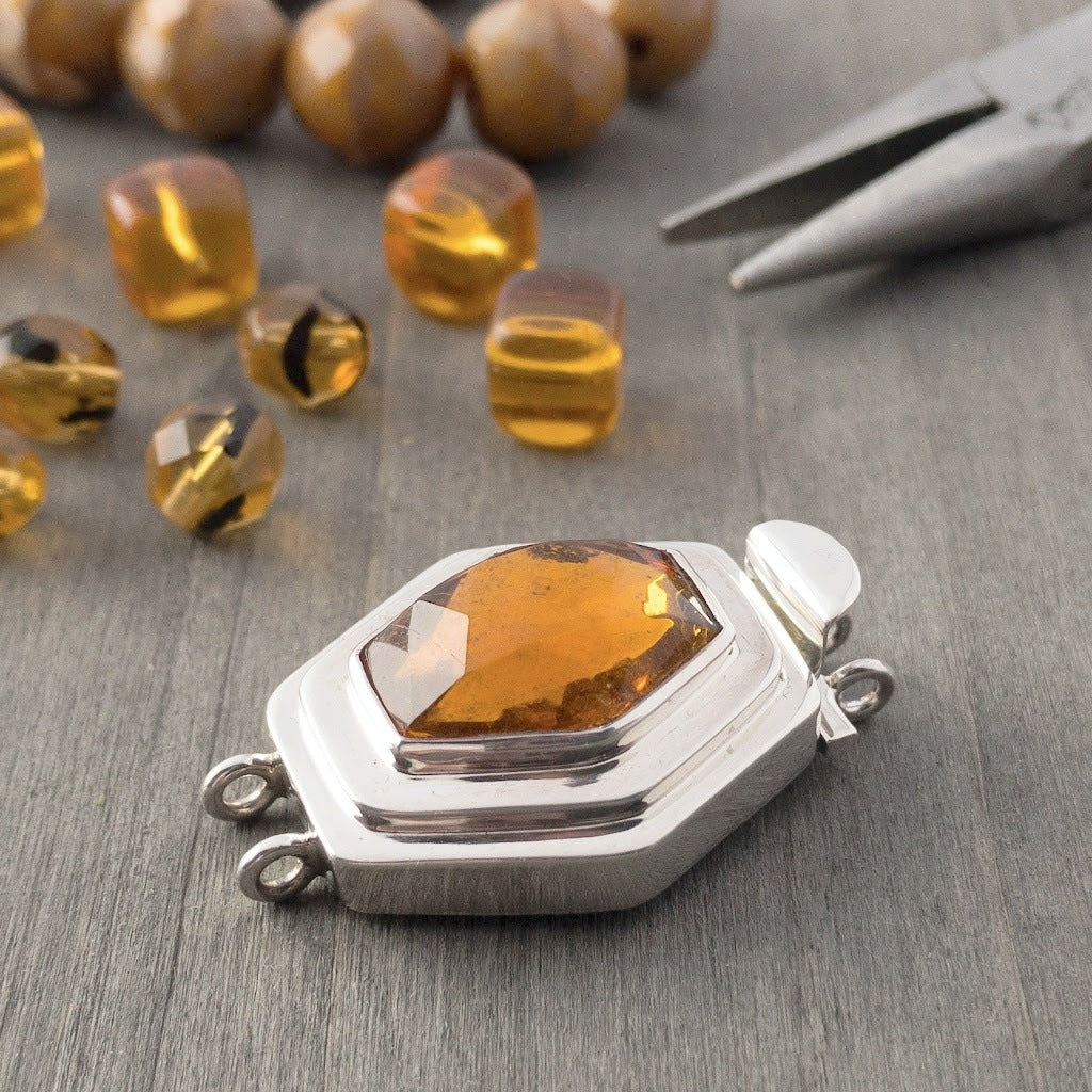In addition to the uncommon diamond shape of the vintage glass cabochon in this double-strand, sterling silver box clasp, the rich amber colour gives this piece an ultra-luscious look, which would totally lend itself to mixing gold metal with the silver, if you were so inclined.