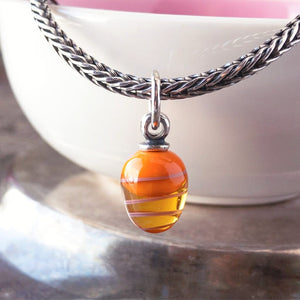 ​Suzie Q Studio's ORANGE TWIRL TASSEL TROLLBEAD is an Easter Egg tassel bead. It fits all major bracelet brands, and also look simply exquisite on a necklace chain. Visit Suzie Q Studio for new stock, never worn, collectible Rare & Retired Trollbeads.