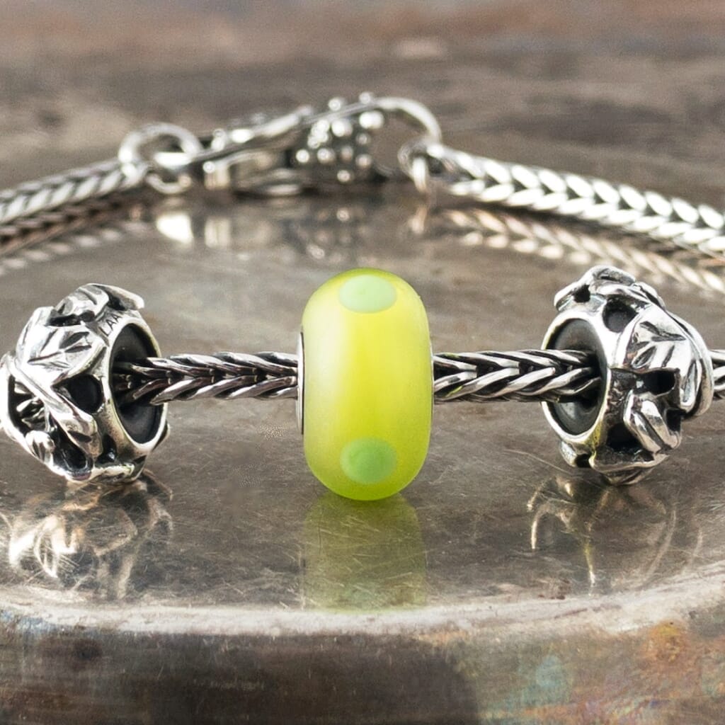 The sandblasted surface of Suzie Q Studio's Green Sand Trollbead absorbs and softens the light in this brightly-coloured bead giving it a luscious inner glow. Visit Suzie Q Studio for new stock, never worn, collectible Rare & Retired Trollbeads.