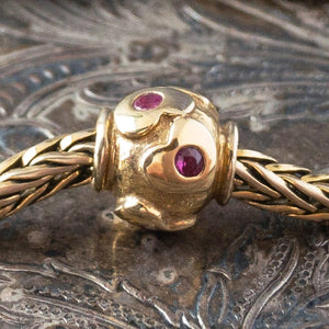 Limited Edition, 18-Karat Gold "heartbeat" Trollbead with four beautiful rubies, worn on an 18KT gold Trollbeads bracelet.